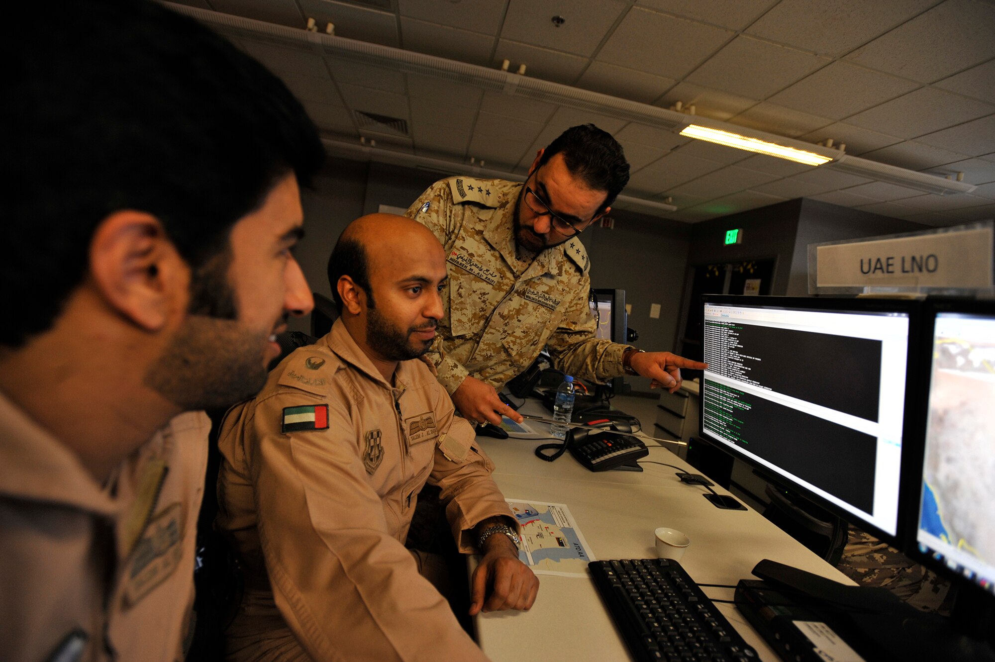 Royal Saudi Air Defense Forces Capt. Mofareh Al-Faifi (far right) coordinates with United Arab Emirates Air Force Maj. Salem Al Kaabi and Capt. Salem Alderei during Arabian Gulf Shield, Feb. 3, 2016, in the Combined Air Operations Center, Al Udeid Air Base, Qatar. Arabian Gulf Shield is the culminating exercise for the Gulf Cooperation Council (GCC) Liaison Officer (LNO) Program. The exercise is designed to exercise GCC LNO procedures and connectivity to host nation Air Operations Centers which improves US-GCC interoperability. (U.S. Air Force photo by Master Sgt. Joshua Strang)