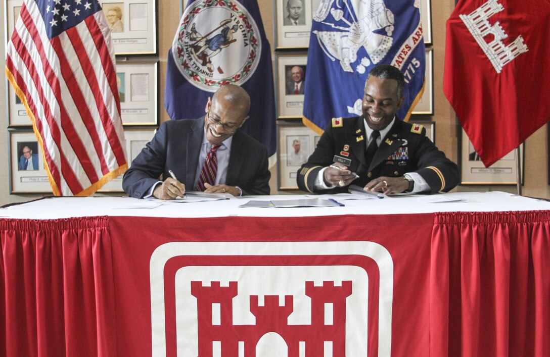 Marcus Jones, Norfolk city manager and Col. Jason Kelly, Norfolk District commander  sign the Feasibility Coast Share Agreement for the Norfolk flood risk management study on February 3, 2016. The agreement allows the Norfolk District to take a comprehensive look at the city of Norfolk to identify potential areas that projects could be constructed to protect the city from flooding and sea-level rise. (U.S. Army photo/Kerry Solan)