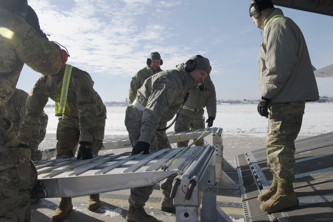 Soldiers and airmen align ramps on a C-17 Globemaster to load 15th Civil Support Team vehicles and trailers as the unit prepares to fly to Puerto Rico for a training evaluation, Jan 24, 2016. The soldiers and airmen are assigned to the Vermont National Guard’s 15th Civil Support Team. This is the first time the unit has airlifted to Puerto Rico for a training proficiency evaluation. Vermont Army National Guard photo by Staff Sgt. Nathan Rivard