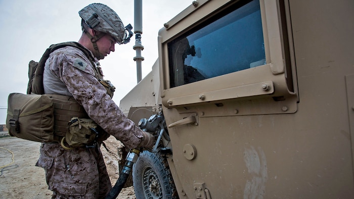 Cpl. Michi Araki, a rifleman with Bravo Company, 1st Battalion, 7th Marine Regiment, Special Purpose Marine Air Ground Task Force-Crisis Response-Central Command, prepares a Humvee prior to conducting a mounted patrol in Al Taqaddum, Iraq, Jan. 1, 2016. U.S. Marines with SPMAGTF-CR-CC are responsible for the force protection of some Combined Joint Task Force – Operation Inherent Resolve bases within the U.S. Central Command area of responsibility.
