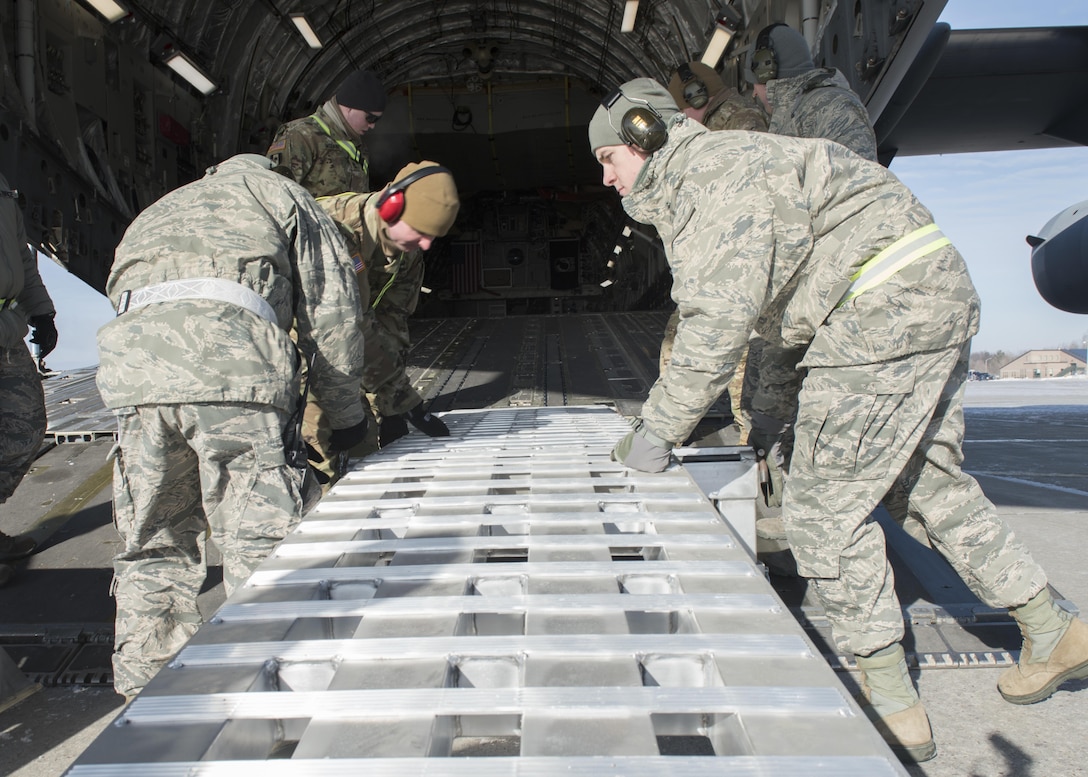 Soldiers and airmen align ramps on a C-17 Globemaster to load 15th Civil Support Team vehicles and trailers as the unit prepares to fly to Puerto Rico for a training evaluation, Jan 24, 2016. Vermont Army National Guard photo by Staff Sgt. Nathan Rivard