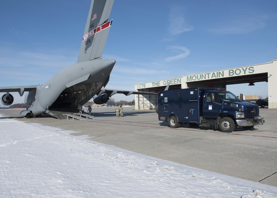 Airmen and soldiers load a C-17 Globemaster as they prepare to fly to Puerto Rico for a unit training evaluation, Jan. 24, 2016. Vermont Army National Guard photo by Staff Sgt. Nathan Rivard