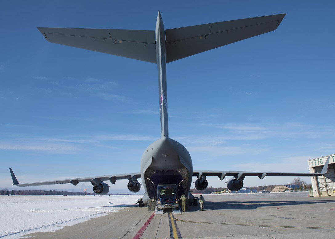 Airmen and soldiers load a C-17 Globemaster as they prepare to fly to Puerto Rico for a unit training evaluation, Jan. 24, 2016. Vermont Army National Guard photo by Staff Sgt. Nathan Rivard