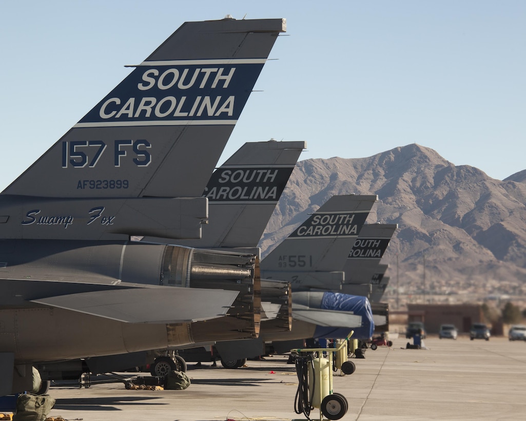 F-16 Fighting Falcons aircraft await the first sortie of the day during exercise Red Flag 16-1 on Nellis Air Force Base, Nev., Jan. 26, 2016. The aircraft are assigned to the South Carolina Air National Guard’s 157th Fighter Squadron, McEntire Joint National Guard Base, S.C. The exercise provides realistic combat training to maximize the combat readiness and survivability of participants by providing a realistic training environment. Air Force photo by Master Sgt. Burt Traynor