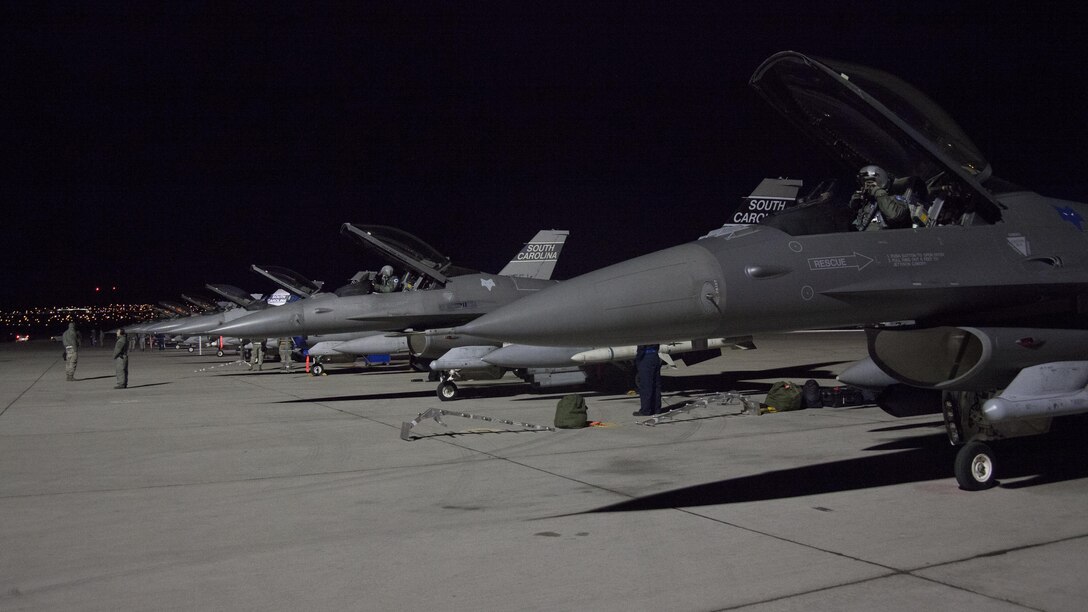 Airmen and pilots prepare F-16 Fighting Falcon aircraft to taxi out for a night training sortie during exercise Red Flag 16-1 on Nellis Air Force Base, Nev., Jan. 26, 2016. Air Force photo by Master Sgt. Burt Traynor