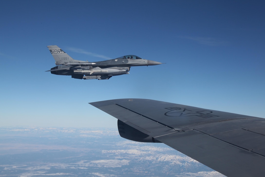 An F-16 Fighting Falcon aircraft waits to refuel beside a KC-135 Stratotanker over the Nevada Test and Training Range during exercise Red Flag-16-1, Jan. 28, 2016. Air Force photo by Master Sgt. Burt Traynor