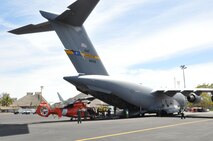 Reservists from the 315th Airlift Wing at Joint Base Charleston, S.C. flew a mission supporting the Coast Guard into Bahias de Huatulco, Mexico, Feb. 7,2016. Here the jet's aircrew from the 300th Airlift Squadron load a Coast Guard helicopter into the back of a C-17. (U.S. Air Force Photo by Maj. Wayne Capps) 