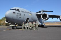 Reservists from the 315th Airlift Wing at Joint Base Charleston, S.C. flew a mission supporting the Coast Guard into Bahias de Huatulco, Mexico, Feb. 7,2016. Here the jet's aircrew from the 300th Airlift Squadron pose for a group photo after lading at the tiny thatch covered airport. (U.S. Air Force Photo by Maj. Wayne Capps) 
