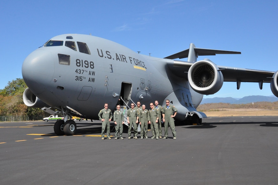 Reservists from the 315th Airlift Wing at Joint Base Charleston, S.C. flew a mission supporting the Coast Guard into Bahias de Huatulco, Mexico, Feb. 7,2016. Here the jet's aircrew from the 300th Airlift Squadron pose for a group photo after lading at the tiny thatch covered airport. (U.S. Air Force Photo by Maj. Wayne Capps) 