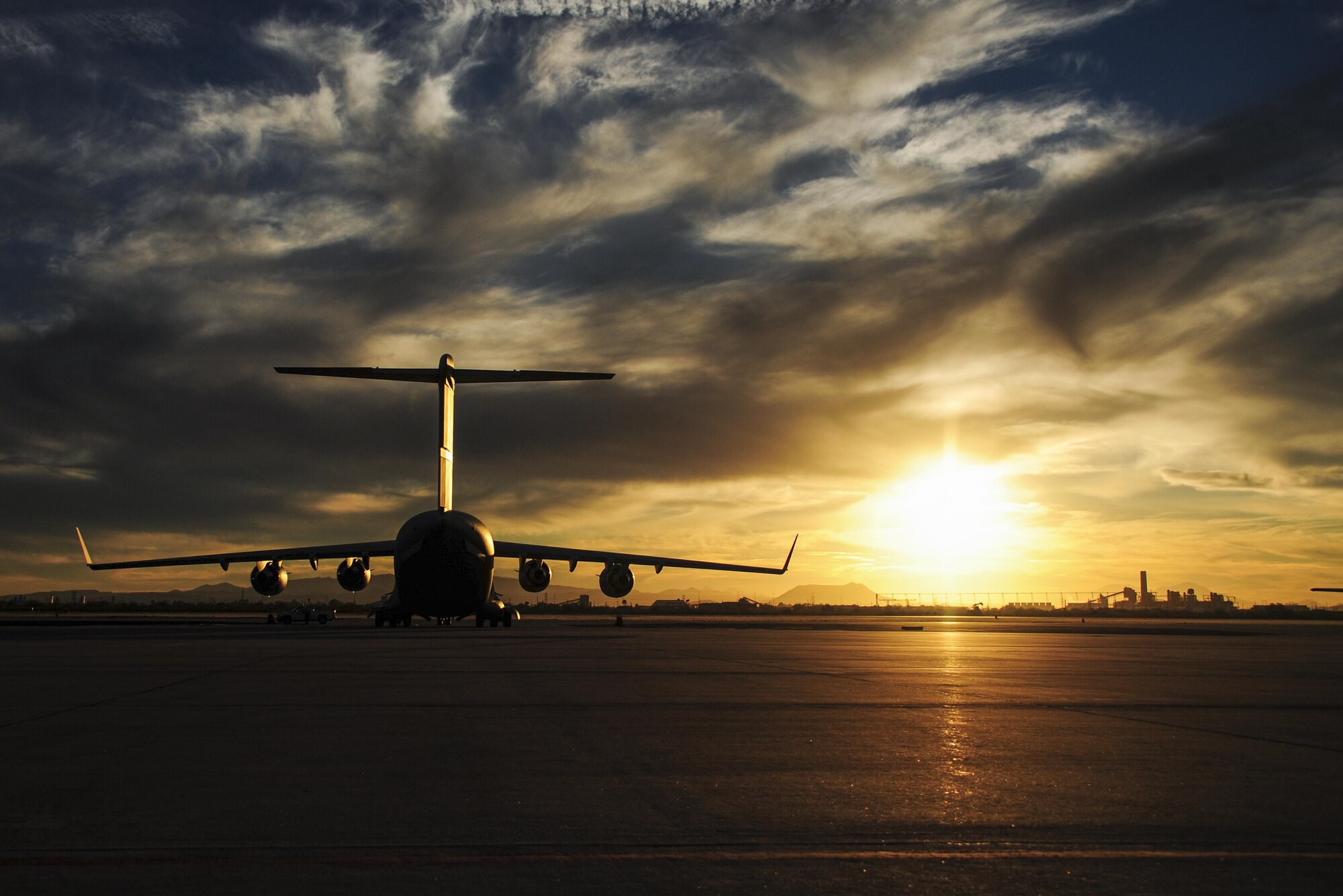 A C-17 from March Air Reserve Base, Calif., sits on the Davis-Monthan Air Force Base flightline at sunset Jan. 28 after delivering the Air Force Reserve Command's first HH-60 to go through Korean Air Lines depot maintenance. During this intensive overhaul, the helicopter is stripped down to nothing and they fix any corrosion before putting it back together so that it’s as fresh as the day it came off the assembly line. “By using KAL, we were able to save both time and money compared to using a stateside depot,” said Maj. Dusty Dossman, 943rd Maintenance Squadron commander. (U.S. Air Force photo by Senior Airman Christopher Drzazgowski)
