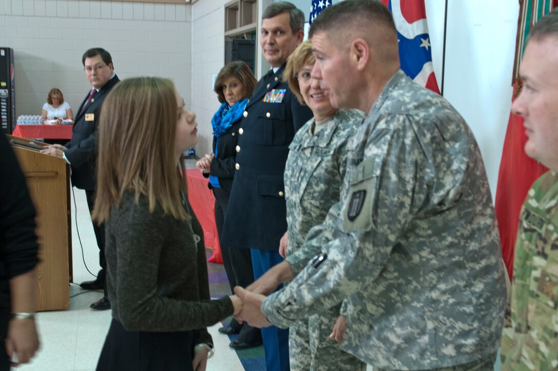Marlee Eckert, daughter of Sgt. Gary Eckert, 983rd Engineer Battalion, talks to Lt. Col. Stephen M. Spineeli, commander, 983rd Engineer Battalion, about her father receiving the Ohio Military Medal of Distinction after being killed in action in May 2005.