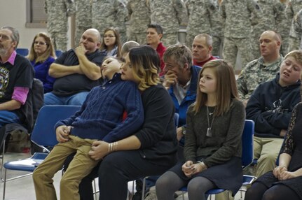 Myles Eckert, son, Tiffany Eckert, wife, and Marlee Eckert, daughter, of Sgt. Gary Eckert, 983rd Engineer Battalion, sit together during the ceremony honoring their father and husband after receiving the Ohio Military Medal of Distinction after being killed in action in May 2005.