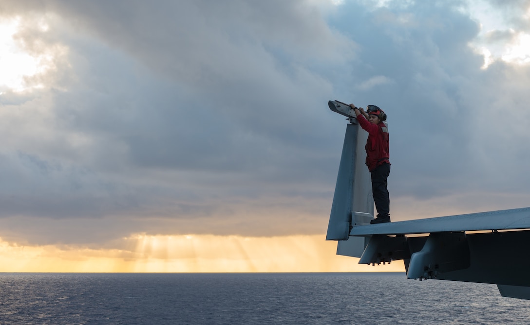 Navy Petty Officer 2nd Class Adeline Dominguez performs a preflight inspection on an F/A18E Super Hornet assigned to the Vigilantes of Strike Fighter Squadron 151 on the flight deck of the USS John C. Stennis in the Pacific Ocean, Jan. 28, 2016. Dominguez is an aviation ordnanceman. Navy photo by Seaman Cole C. Pielop