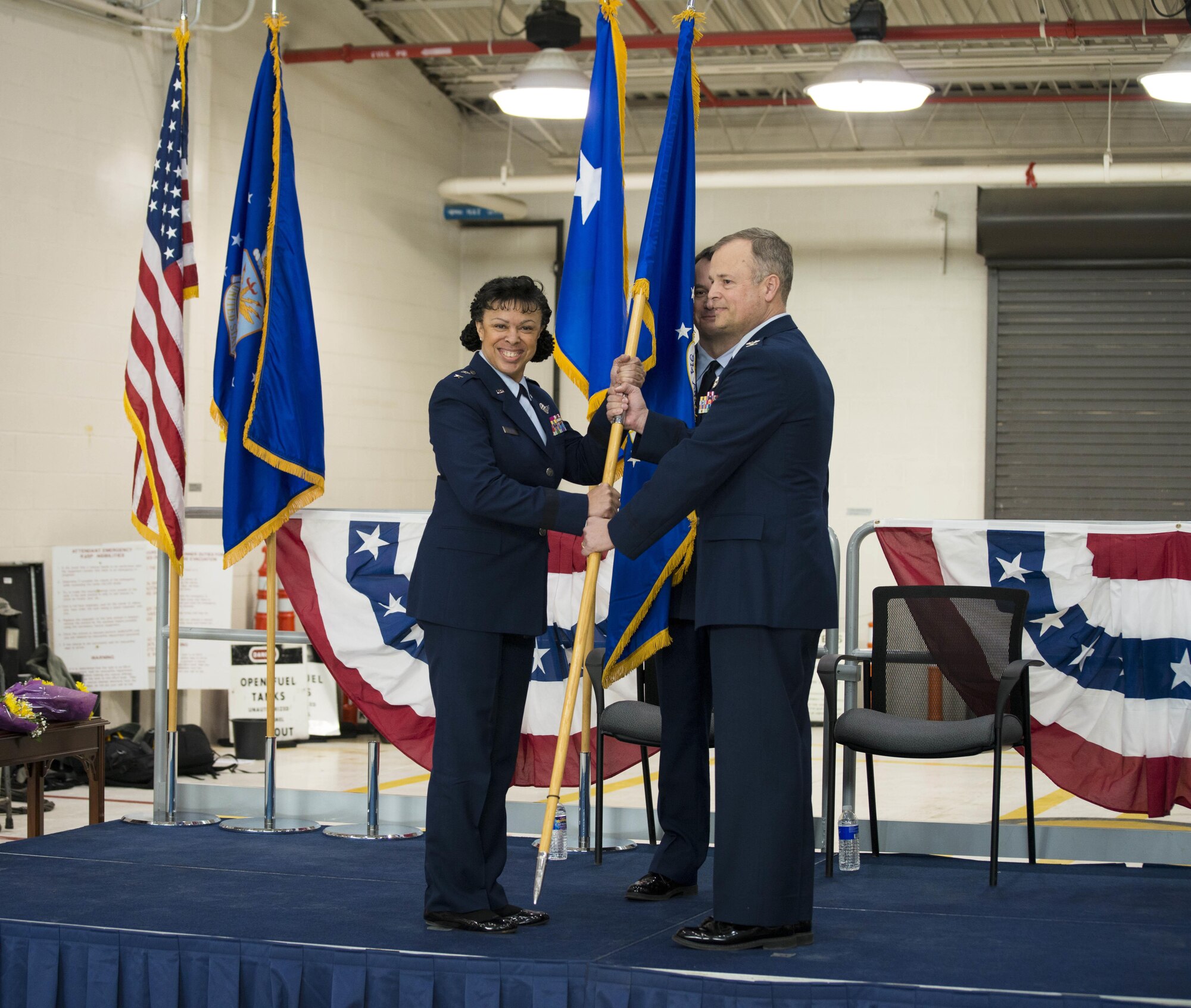 Maj. Gen. Stayce D. Harris, 22nd Air Force commander, Dobbins Air Reserve Base, Georgia,  passes the 914th Airlift Wing flag to Col. Brian S. Bowman as he assumes command of the wing at Niagara Falls Air Reserve Station, N.Y., Feb. 6. (U.S. Air Force photo by Tech. Sgt. Stephanie Sawyer) 
