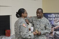 Army Cpt. Prince Zawolo, the incoming recruiting officer for the Chicago Recruiting Battalion, has a discussion with Army Sgt. 1st Class Stacy Muse, the Army Reserve’s operations noncommissioned officer in charge, over coffee and donuts. Recruiters gathered around the Armed Forces Reserve Center in Forest Park, Ill., Jan. 9, 2016.