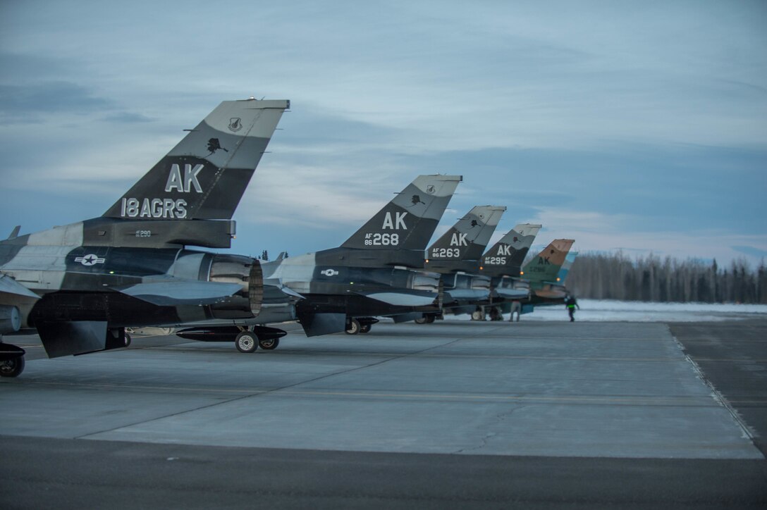 Air Force F-16 Fighting Falcon aircraft prepare to take off from Eielson Air Force Base, Alaska, Jan. 24, 2016, to fly to Kadena Air Base, Japan, to participate in training exercises. Air Force photo by Staff Sgt. Shawn Nickel