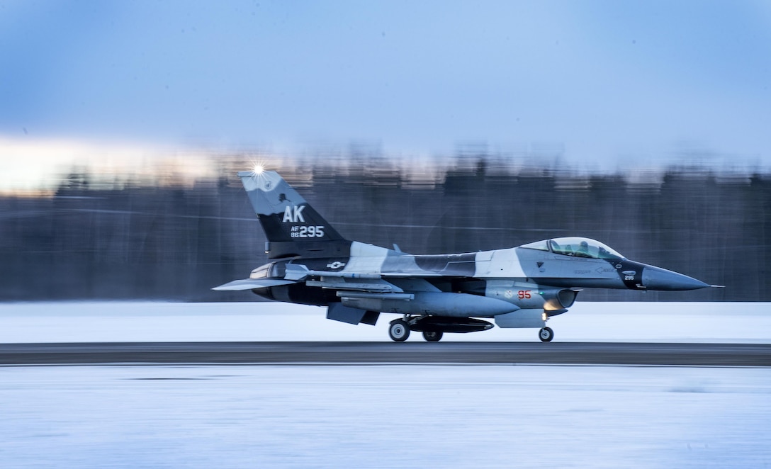 An Air Force F-16 Fighting Falcon aircraft takes off from Eielson Air Force Base, Alaska, Jan. 24, 2016 to fly to Kadena Air Base, Japan to participate in training exercises. Air Force photo by Staff Sgt. Shawn Nickel
