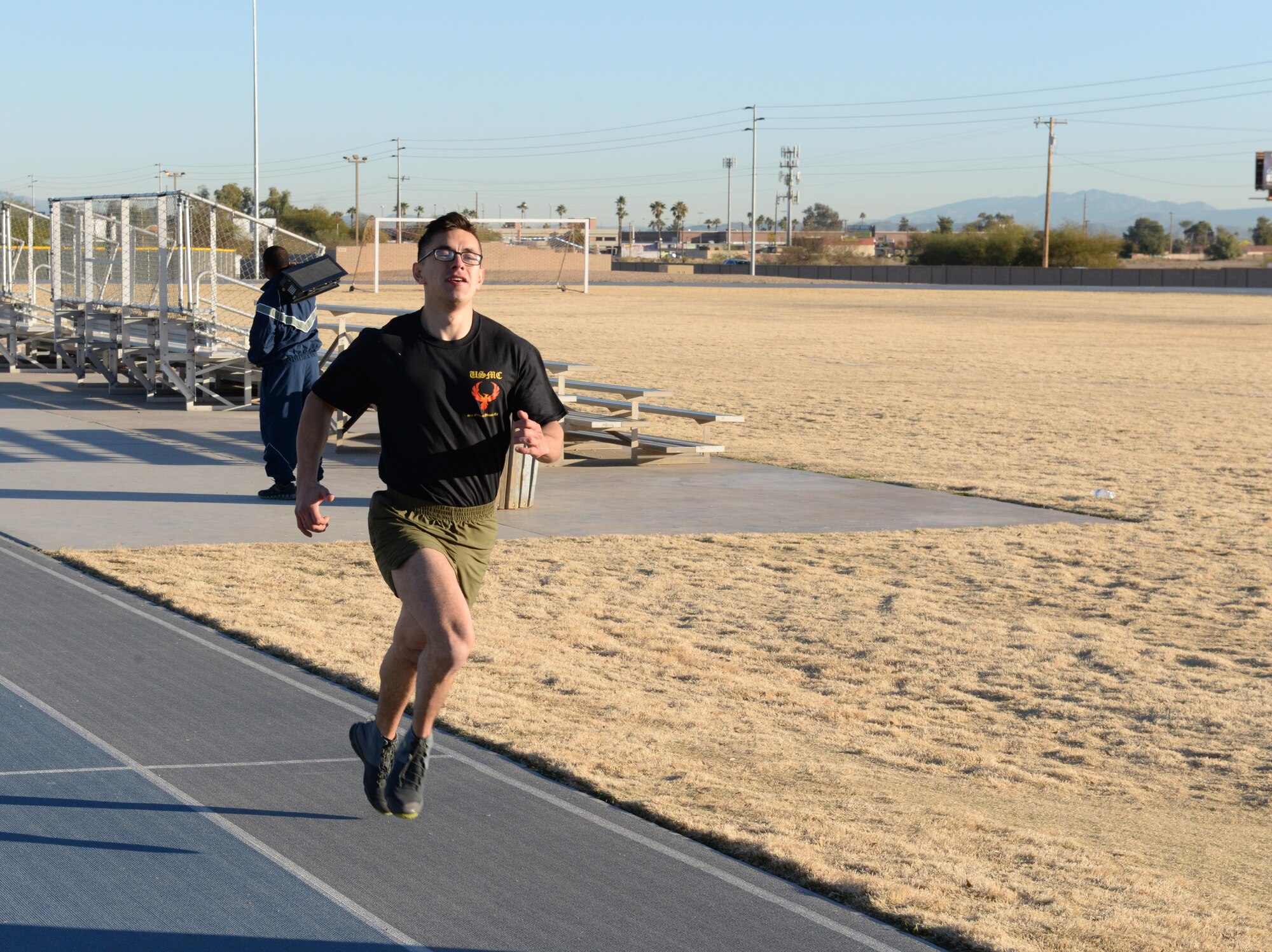 Cpl. Dereck Rascon, 6th Engineer Support Battalion heavy equipment mechanic, sprints the final few meters of his lap during the Luke Bryant Fitness Center squadron PT challenge to bring the Marine team to the finish line, Feb. 5, 2016. Despite a close fight between the fitness center’s team of staff and Airmen and the Marines of the 6th ESB, the Marines edged out a victory at the end of the competition with a strong performance during the race. 