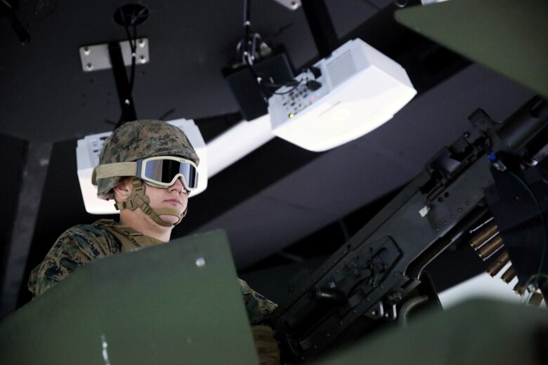 A Marine with 5th Battalion, 11th Marine Regiment, 1st Marine Division, loads an electronic M2 .50-caliber machine gun in a Combat Convoy Simulator aboard Marine Corps Base Camp Pendleton, Calif., Feb. 2, 2016. The CCS at first glance looks like an expensive, high-tech video game, but its primary use is preparing Marines for real-world combat missions with simulations of realistic scenarios.