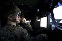 A Marine with 5th Battalion, 11th Marine Regiment, 1st Marine Division, establishes communications with the combat operation center in a Combat Convoy Simulator aboard Marine Corps Base Camp Pendleton, Feb. 2, 2016. The CCS at first glance looks like an expensive, high-tech video game, but its primary use is preparing Marines for real-world combat missions with simulations of realistic scenarios.