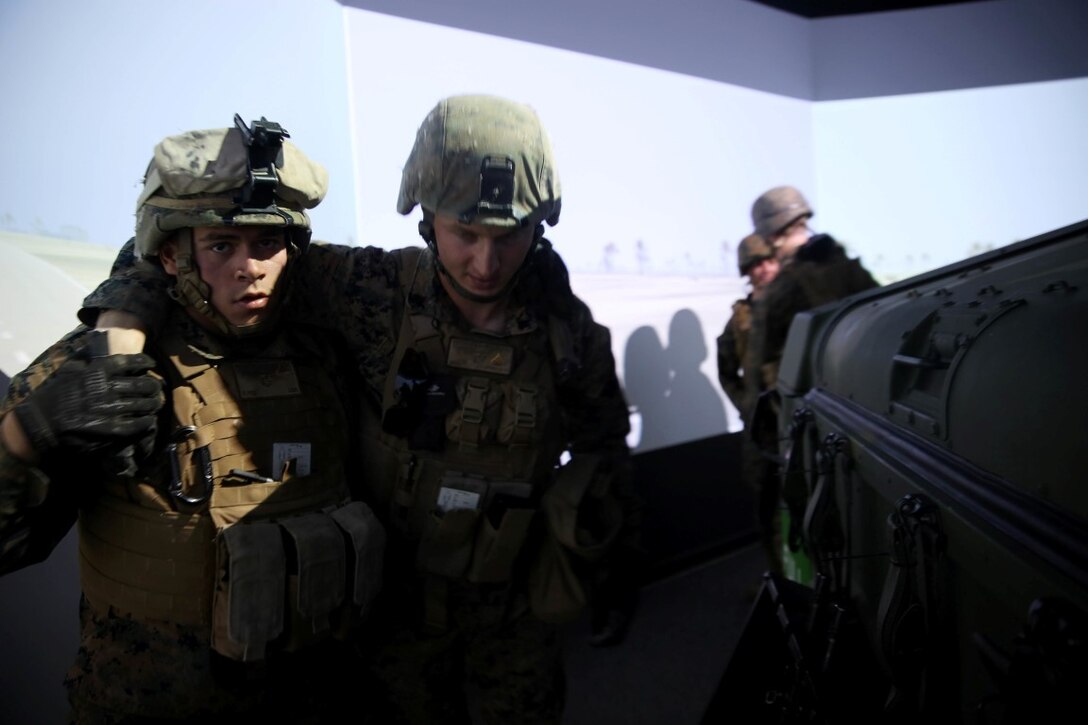 Marines with 5th Battalion, 11th Marine Regiment, 1st Marine Division, carry Marines to their designated vehicle in a Combat Convoy Simulator aboard Marine Corps Base Camp Pendleton, Feb. 2, 2016. The CCS at first glance may look like a really expensive, high-tech video game but its primary use is preparing Marines for real-world combat missions with inexpensive simulations of realistic scenarios.