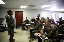 Marines with 5th Battalion, 11th Marine Regiment, 1st Marine Division, conduct an after action brief during virtual combat convoy training aboard Marine Corps Base Camp Pendleton, Feb. 2, 2016. The CCS at first glance looks like an expensive, high-tech video game, but its primary use is preparing Marines for real-world combat missions with simulations of realistic scenarios.
