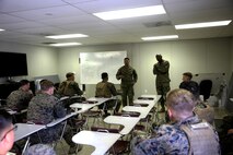 Marines with 5th Battalion, 11th Marine Regiment, 1st Marine Division, conduct an after action brief during virtual combat convoy training aboard Marine Corps Base Camp Pendleton, Feb. 2, 2016. The CCS at first glance looks like an expensive, high-tech video game, but its primary use is preparing Marines for real-world combat missions with simulations of realistic scenarios.