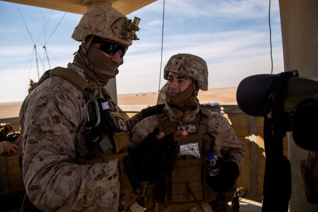 U.S. Marine Corps Cpl. Sheldon Muse, radio operator with 1st Air Naval Gunfire Liason Company and Cpl. Jeremy Naughton, forward observer, with 1st Batallion, 11th Marine Regiment, both attached to Special Purpose Marine Air Ground Task Force-Crisis Response-Central Command (SPMAGTF-CR-CC), observe simulated enemy positions during exercise Eager Centaur in an undisclosed location, Southwest Asia, Feb. 2, 2016. Eager Centaur is conducted to complete initial joint terminal attack controller training and exercise the MAGTF Fire Support Coordination Center, to include combined arms live fire tactics, techniques and procedures. (U.S. Marine Corps photo by Cpl. Akeel Austin/Released)