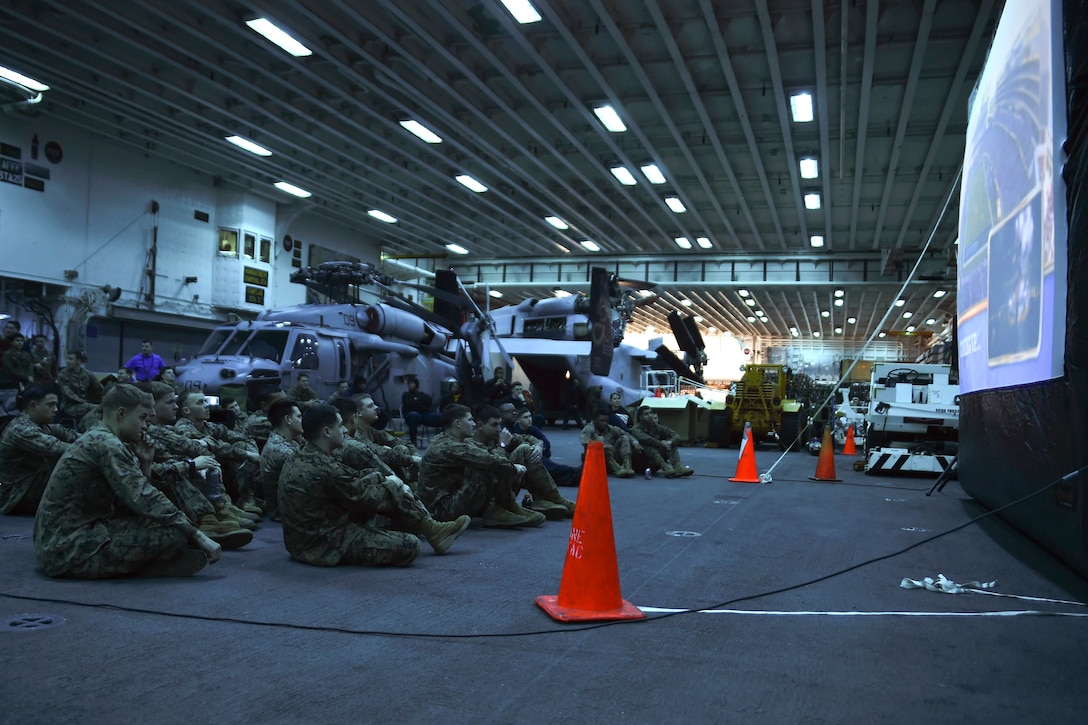 Sailors and Marines watch Super Bowl 50 in the hangar bay of the USS Bonhomme Richard in the Pacific Ocean, Feb. 8, 2016. Navy photo by Petty Officer 2nd Class Naomi VanDuser
