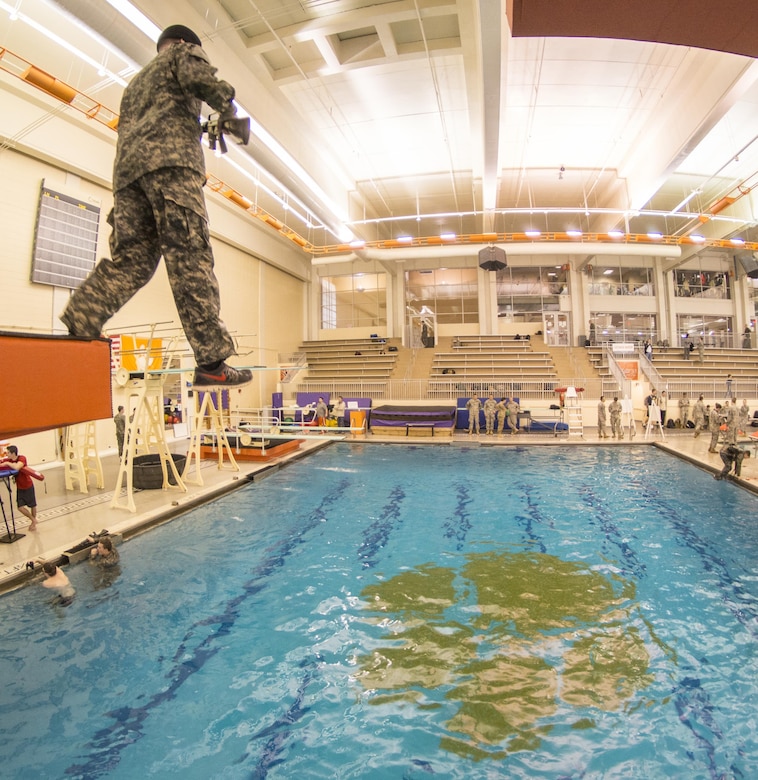 A blindfolded U.S. Army Reserve Officers' Training Corps cadet steps off a five-meter diving board while taking the Combat Water Survival Test at Clemson University, Jan. 28, 2016. (U.S. Army photo by Staff Sgt. Ken Scar)