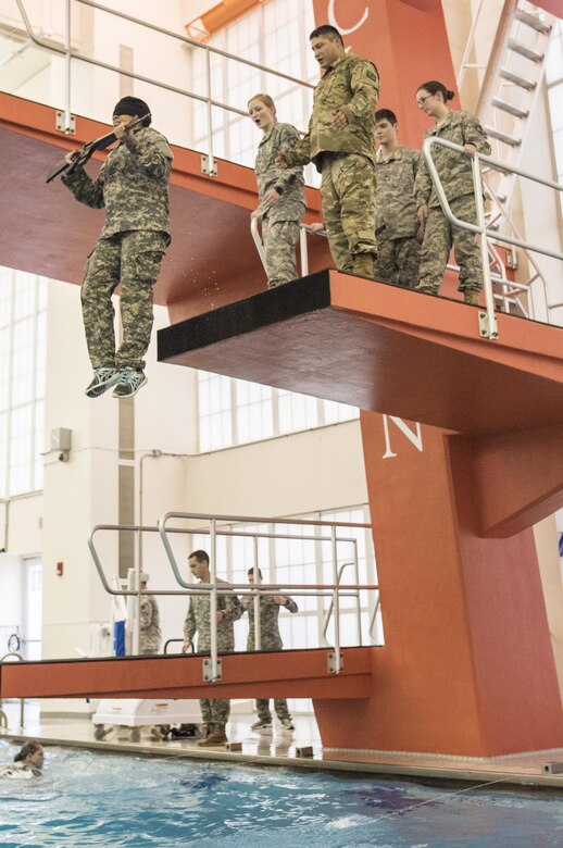 Clemson University Reserve Officers' Training Corps cadet Kristina Jackson, 19, a freshman studying civil engineering from Swansboro N.C., drops into the Fike Recreation Center pool - blindfolded and carrying and M16 - to pass the “five-meter drop” portion of the Combat Water Survival Test, Jan. 28, 2016. (U.S. Army photo by Staff Sgt. Ken Scar)