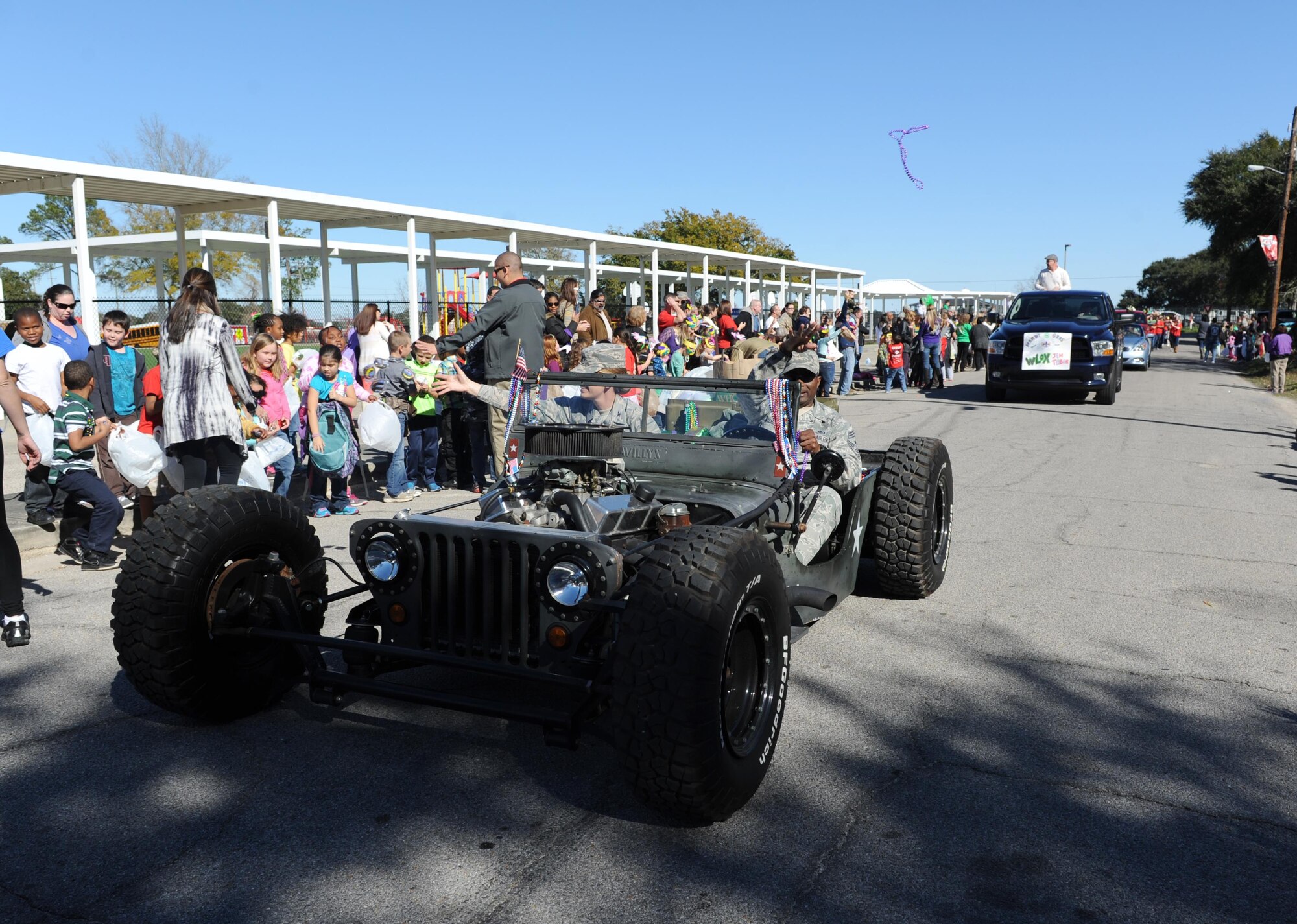 Col. Michele Edmondson, 81st Training Wing commander, and Chief Master Sgt. Harry Hutchinson, 81st TRW command chief, serve as Grand Marshalls during the Jeff Davis Elementary School Mardi Gras Parade, Feb. 5, 2016, Biloxi, Miss. The Keesler Honor Guard and other base personnel also participated in the festivities. (U.S. Air Force photo by Kemberly Groue)