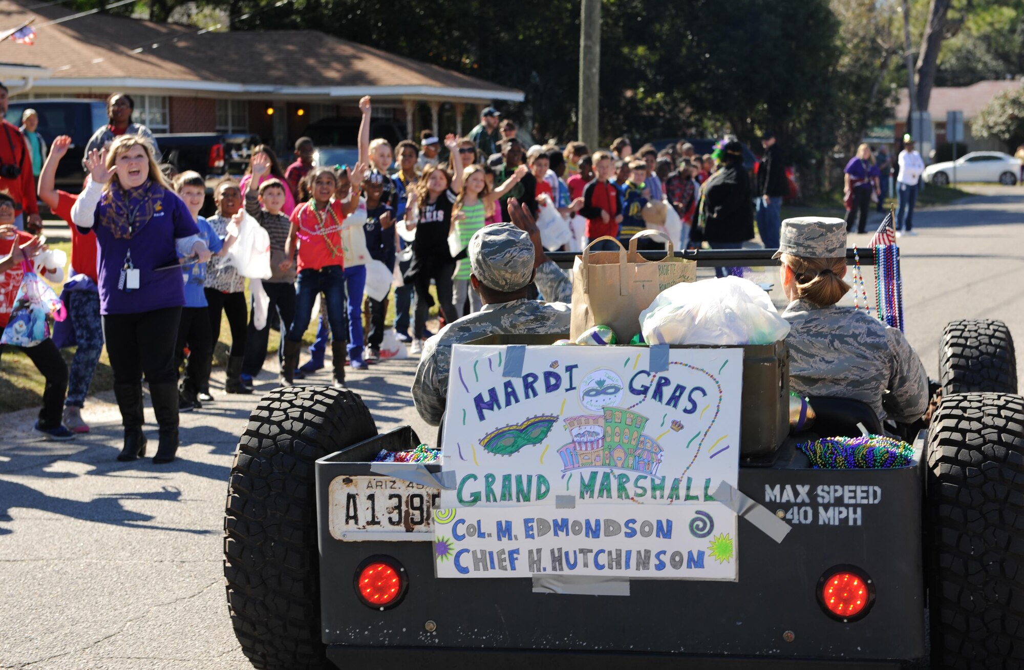 Chief Master Sgt. Harry Hutchinson, 81st Training Wing command chief, and Col. Michele Edmondson, 81st TRW commander, serve as Grand Marshalls during the Jeff Davis Elementary School Mardi Gras Parade, Feb. 5, 2016, Biloxi, Miss. The Keesler Honor Guard and other base personnel also participated in the festivities. (U.S. Air Force photo by Kemberly Groue)