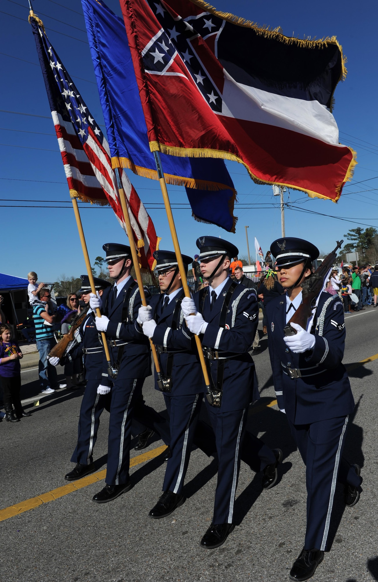 Members of the Keesler Air Force Base Honor Guard lead the North Bay Area Mardi Gras Parade Feb. 7, 2016, St. Martin, Miss. Every Mardi Gras season, Keesler participates in local parades to be involved with the community. (U.S. Air Force photo by Kemberly Groue)
