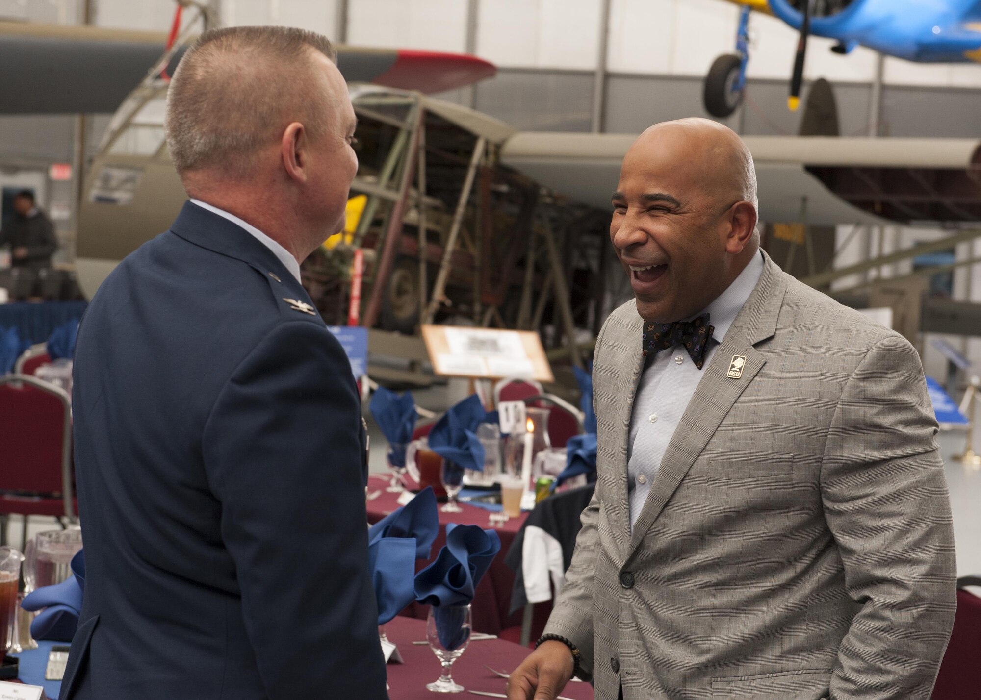 Kenny Carter, Delaware State University head football coach, and Col. D. Scott Durham, 512th Airlift Wing commander, reminisce about their college days Feb. 6, 2016, at the Air Mobility Command Museum prior to the Honorary Commander Induction Ceremony. After Carter's selection to serve as an honorary commander for the 512th Maintenance Squadron, the two learned they both attended The Citadel, in S.C., where they both graduated the same year. (U.S. Air Force/Senior Airman Zachary Cacicia)
