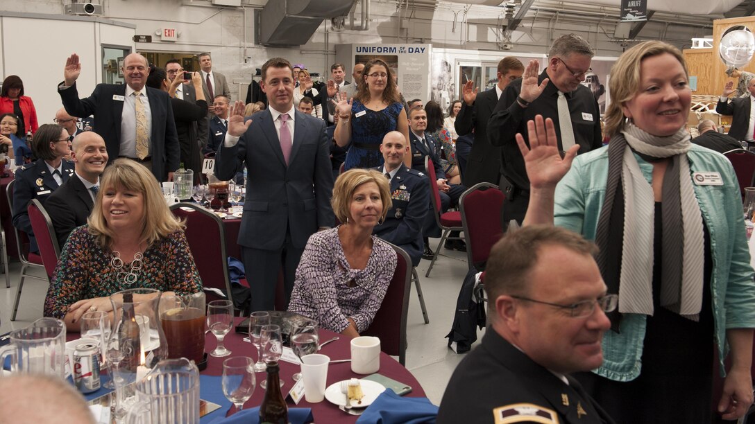 A crowd of educators, legislators and business professionals take an oath acknowledging their appointment and commitment to Team Dover's Honorary Commander Program during a ceremony Feb. 6, 2016, at the Air Mobility Command Museum, Dover, Del. There are 35 honorary commanders assigned throughout Dover Air Force Base, Del., for the 2016 season. (U.S. Air Force photo/Senior Airman Zachary Cacicia)