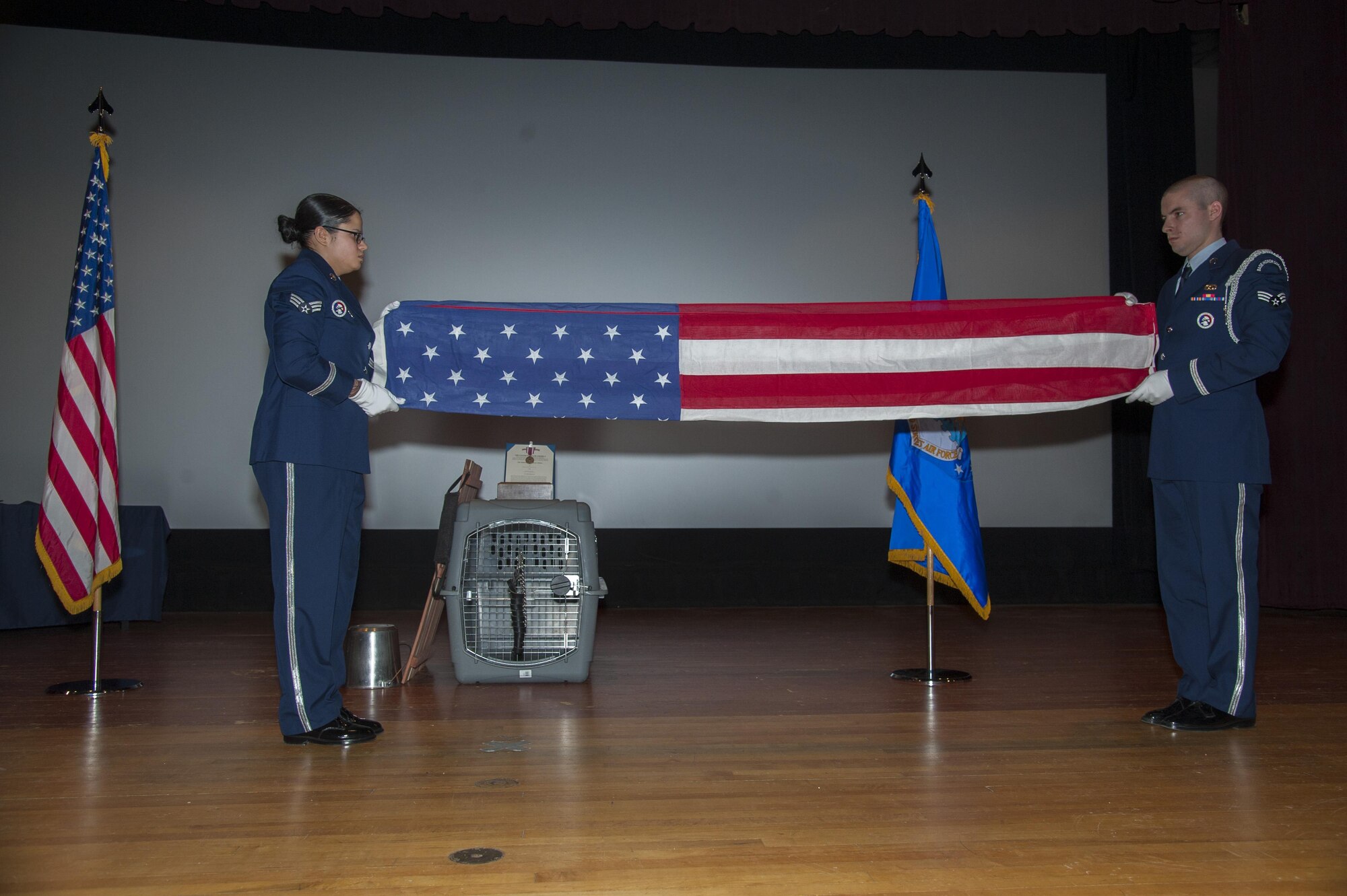 Members of the Minot Air Force Base honor guard perform the flag folding ceremony during Military Working Dog Kitty’s memorial service at Minot AFB, N.D., Feb. 2, 2016. Kitty had been retired for a month when she died of an illness. (U.S. Air Force photo/Airman 1st Class Christian Sullivan)