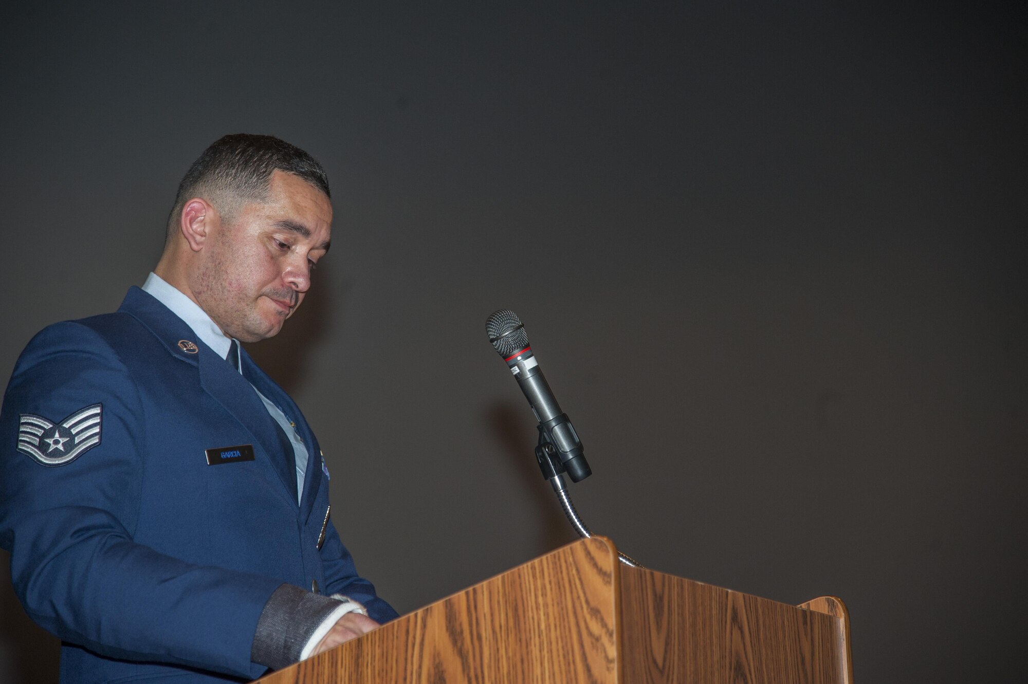Staff Sgt. Roland Garcia, 5th Security Forces Squadron military working dog handler, speaks at MWD Kitty's memorial service at Minot Air Force Base, N.D., Feb. 2, 2016. Garcia was Kitty's last handler and her adoptibe owner. (U.S. Air Force photo/Airman 1st Class Christian Sullivan)