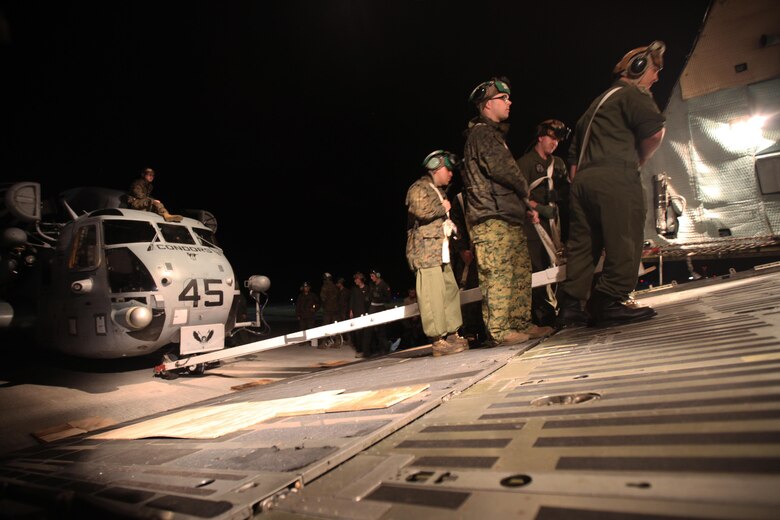 Marines with Marine Heavy Helicopter Squadron 464 guide a CH-53E Super Stallion as it is winched onto a C-5 Galaxy in preparation for Operation Cold Response 2016 at Marine Corps Air Station Cherry Point, N.C., Feb. 3, 2016. The key purpose of Cold Response is to train and educate participants on how to conduct combat operations in a cold weather environment. Up to 2,000 Marines and 15,000 military personnel from 14 nations will attend the North Atlantic Treaty Organization-level exercise. (U.S. Marine Corps photo by Pfc. Nicholas P. Baird/Released)