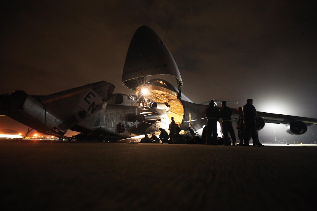 Marines with Marine Heavy Helicopter Squadron 464 load a CH-53E Super Stallion onto a C-5 Galaxy in preparation for Operation Cold Response 2016 at Marine Corps Air Station Cherry Point, N.C., Feb. 3, 2016. The key purpose of Cold Response is to train and educate participants on how to conduct combat operations in a cold weather environment. Up to 2,000 Marines and 15,000 military personnel from 14 nations will attend the North Atlantic Treaty Organization-level exercise. (U.S. Marine Corps photo by Pfc. Nicholas P. Baird/Released)