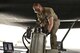 Airman 1st Class James Balcom, 37th Aircraft Maintenance Unit crew chief, fills the auxiliary power unit of a B1-B Lancer as part of his final inspections to ready the aircraft before an aircrew boards for a mission Sept. 22, 2015 at Al Udeid Air Base, Qatar. Balcom is deployed from Ellsworth Air Force Base, S.D. (U.S. Air Force photo/Staff Sgt. Alexandre Montes)