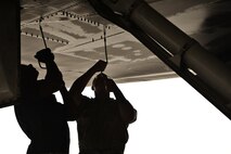 Tech. Sgt Nasir Ahmad and Airman 1st Class James Balcom, 37th Aircraft Maintenance Unit crew chiefs, remove a panel underneath a B1-B Lancer to check for leaks as part of a final pre-flight inspection Sept. 22, 2015 at Al Udeid Air Base, Qatar. Ahmad and Balcom are deployed from Ellsworth Air Force Base, S.D. (U.S. Air Force photo/Staff Sgt. Alexandre Montes)
