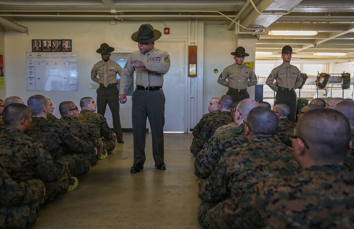 A senior drill instructor of Golf Company, 2nd Recruit Training Battalion, speaks to his new recruits during pick up at Marine Corps Recruit Depot San Diego, Feb. 5. After spending the first week in-processing, recruits marched to their new squad bay where their drill instructors introduced themselves, recited the Drill Instructor Creed and began to carry out the mission of transforming civilians into United States Marines. Annually, more than 17,000 males recruited from the Western Recruiting Region are trained at MCRD San Diego. Golf Company is scheduled to graduate April 29.