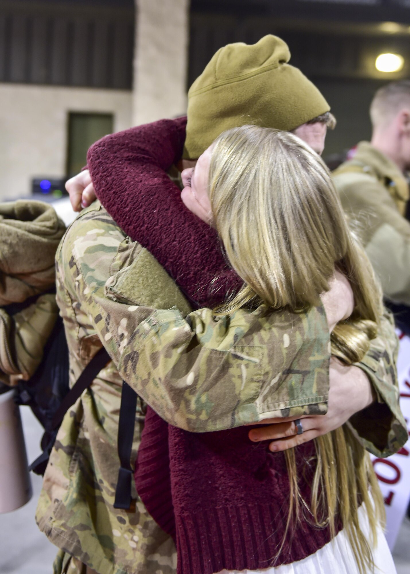 Senior Airman Bryce Evans, a maintenance scheduler with the 1st Special Operations Maintenance Group, reunites with his wife during Operation Homecoming at Hurlburt Field, Fla., Feb. 7, 2016. Operation Homecoming welcomed 106 Airmen home from their deployment overseas. (U.S. Air Force photo by Senior Airman Jeff Parkinson)