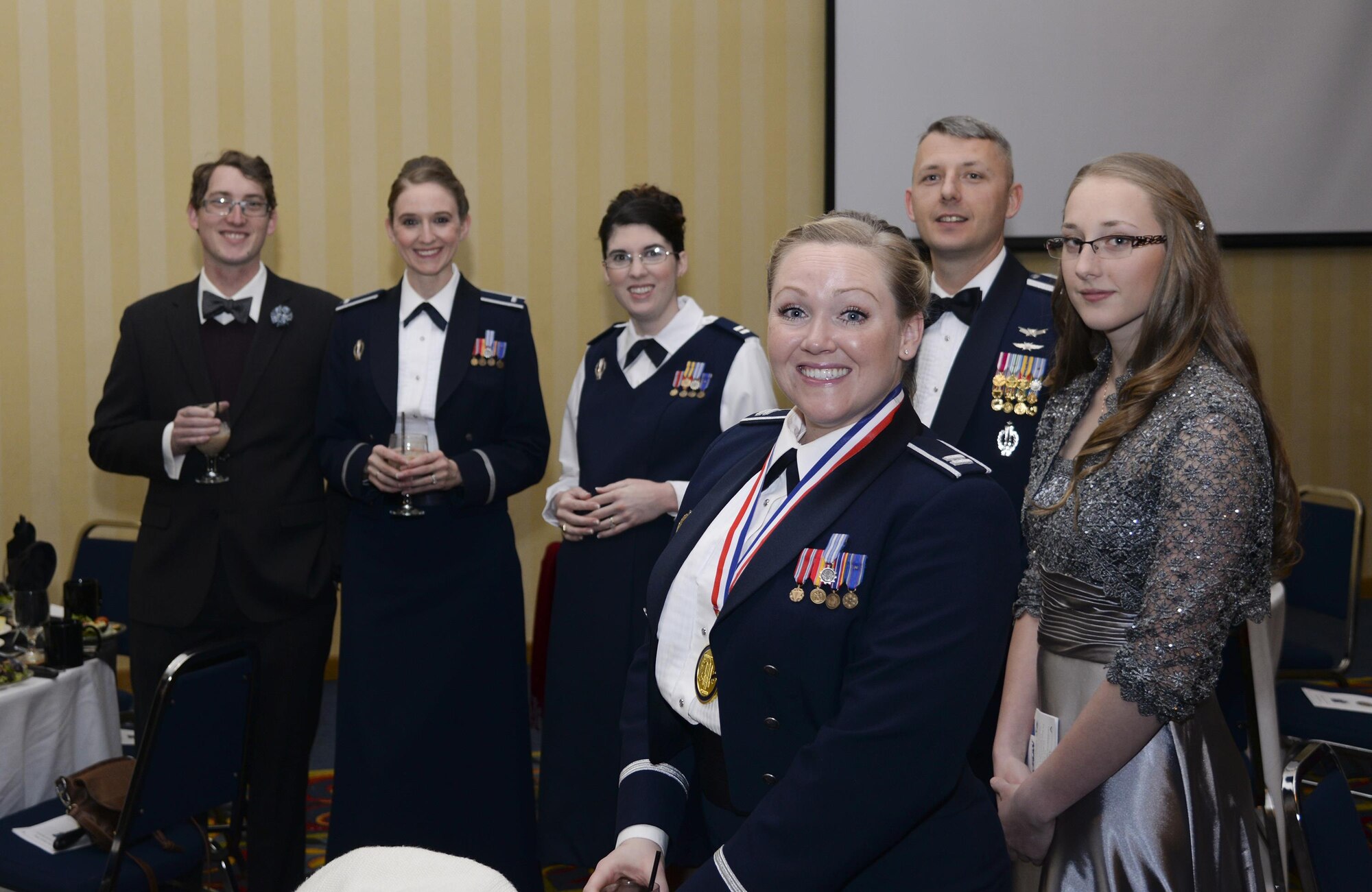 Capt. Carli Frasier, 90th Operations Group, poses for a photo with her OG comrades during the social hour of the F.E. Warren Air Force Base 90th Missile Wing 2015 Annual Awards Ceremony Feb. 5, 2016, in the Cheyenne, Wyo., Holiday Inn. Frasier won the company grade officer-of-the-year award. (U.S. Air Force photo by Senior Airman Jason Wiese)