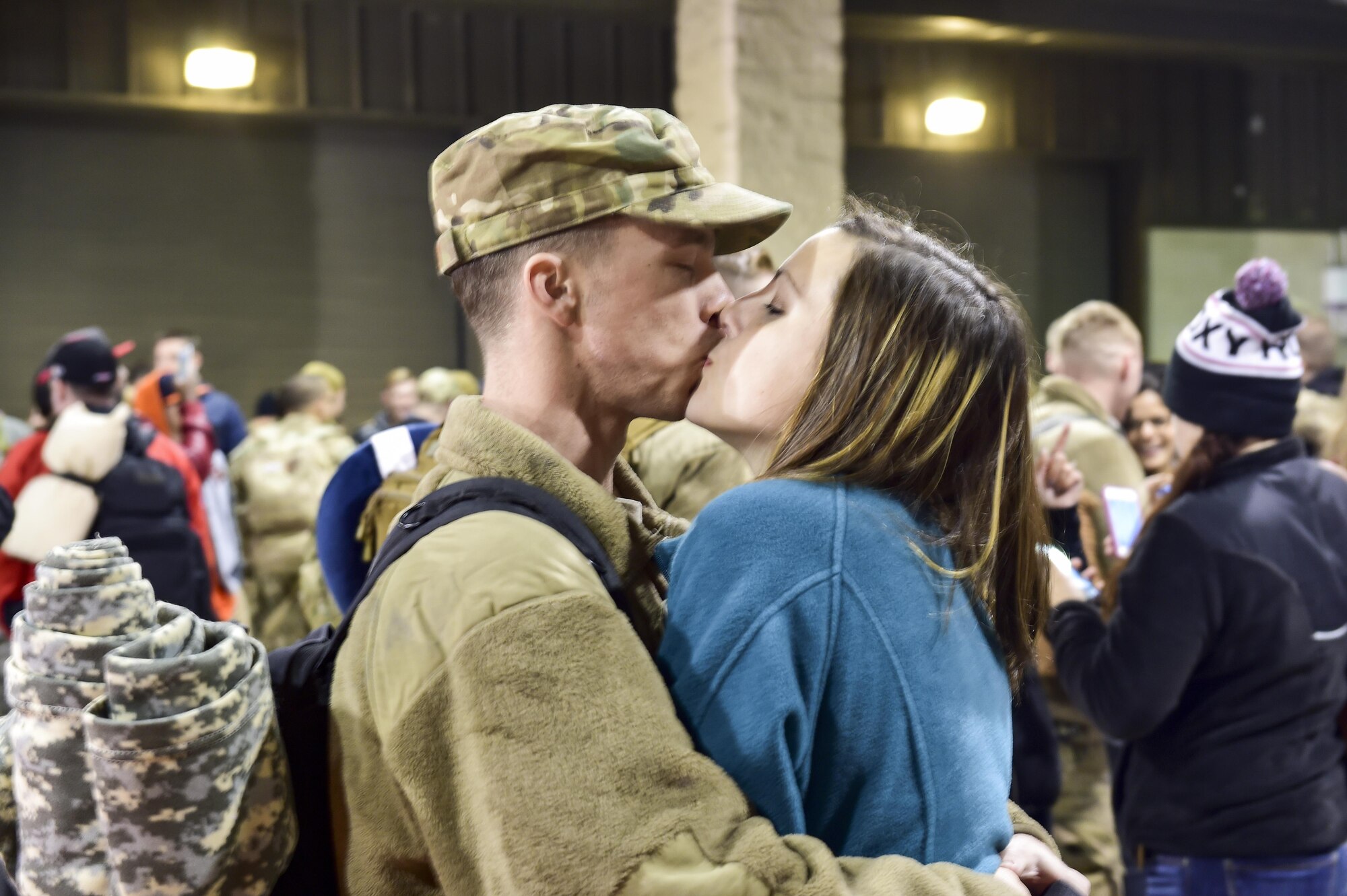 Airman 1st Class Martin Henry, a combat aircraft ground equipment team apprentice with the 1st Special Operations Maintenance Squadron, kisses his wife during Operation Homecoming at Hurlburt Field, Fla., Feb. 7. 2016. Operation Homecoming welcomed 106 Airmen home from their deployment overseas. (U.S. Air Force photo by Senior Airman Jeff Parkinson)