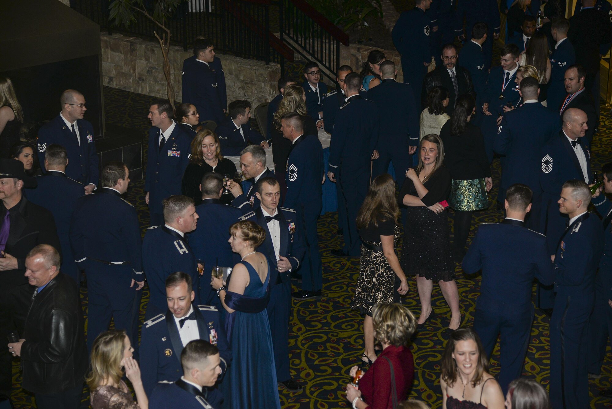 A crowd of 90th Missile Wing Airmen and families mingle in the Cheyenne, Wyo., Holiday Inn lobby during the F.E. Warren Air Force Base 90th MW 2015 Annual Awards Ceremony social hour Feb. 5, 2016. Supervisors, commanders, friends, spouses and even children came out to support their loved ones who were nominated for one of 12 award categories. (U.S. Air Force photo by Senior Airman Jason Wiese)