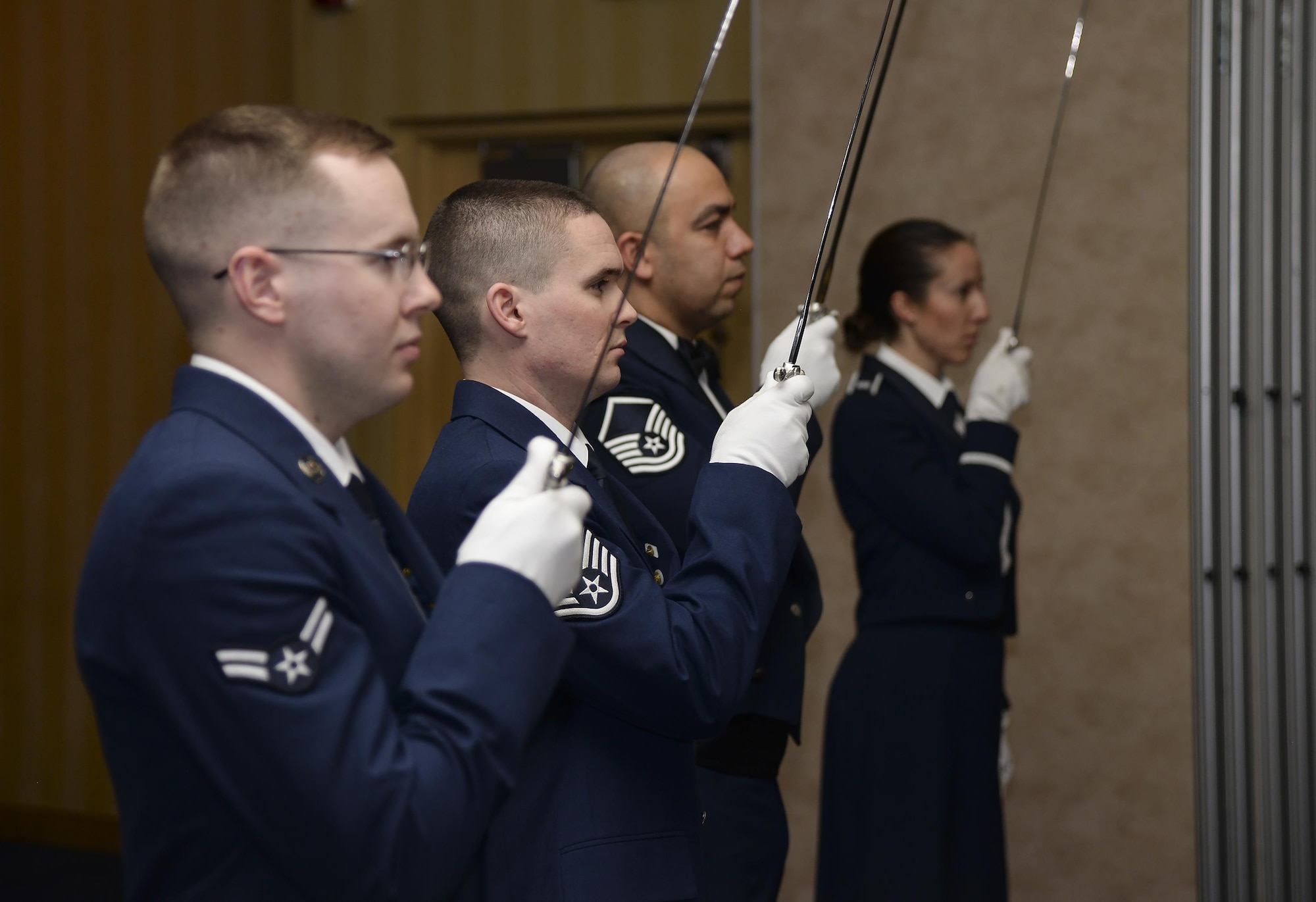 One side of the F.E. Warren Air Force Base 90th Missile Wing 2015 Annual Awards Ceremony saber team prepares to form an arch with their sabers for the ceremonious entrance of award nominees to the dining area Feb. 5, 2016, in the Cheyenne, Wyo., Holiday Inn. Each year, the wing honors teammates in 12 categories, ranging from Airman of the year to company grade officer of the year to civilian categories. (U.S. Air Force photo by Senior Airman Jason Wiese)