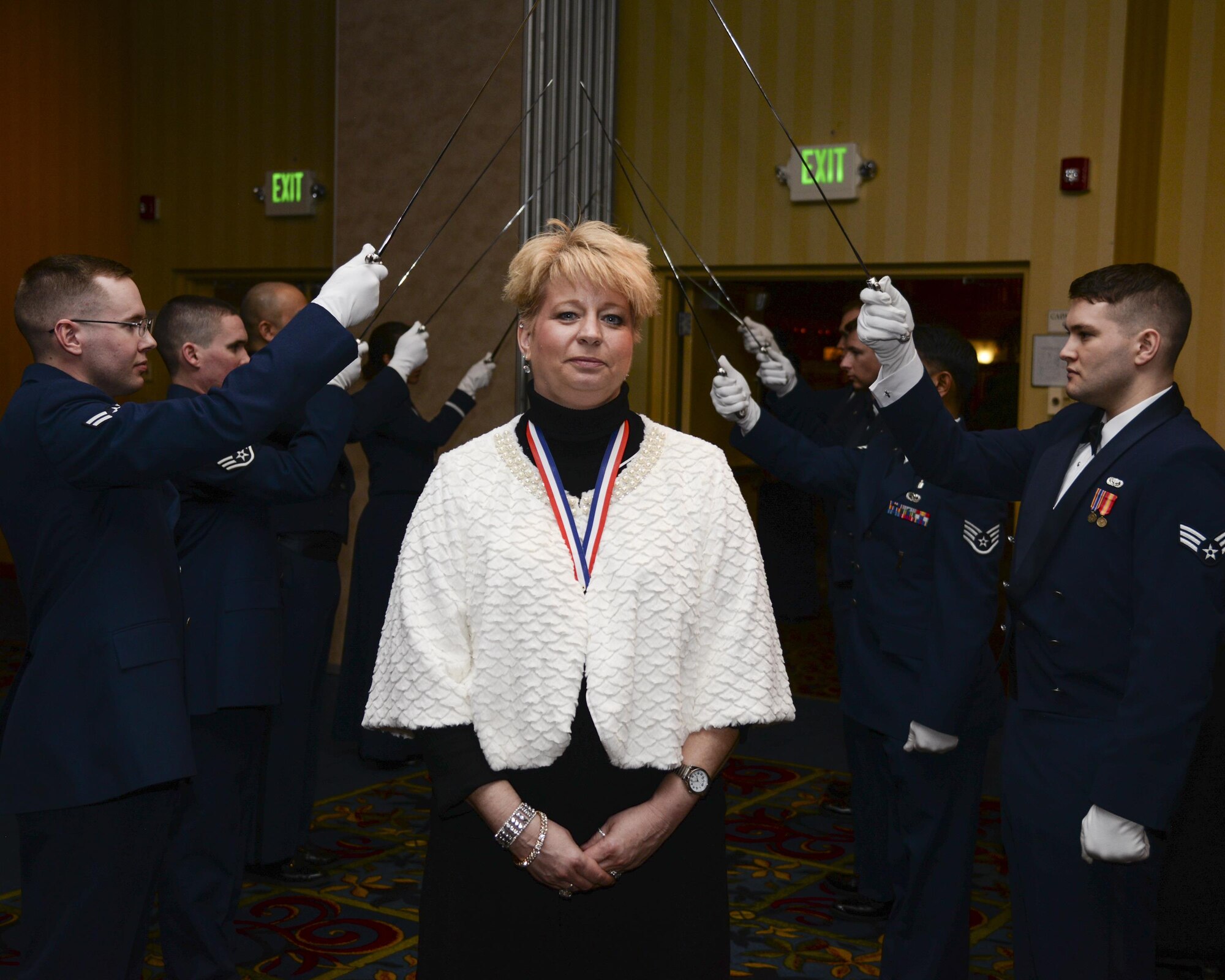 Karmella Van Stockum, 90th Force Support Squadron chief of education and training, poses in front of the saber arch Feb. 5, 2016, in the Cheyenne, Wyo., Holiday Inn during the F.E. Warren Air Force Base 90th Missile Wing 2015 Annual Awards Ceremony. Van Stockum went on to win civilian category II, supervisory, of the year. (U.S. Air Force photo by Senior Airman Jason Wiese)