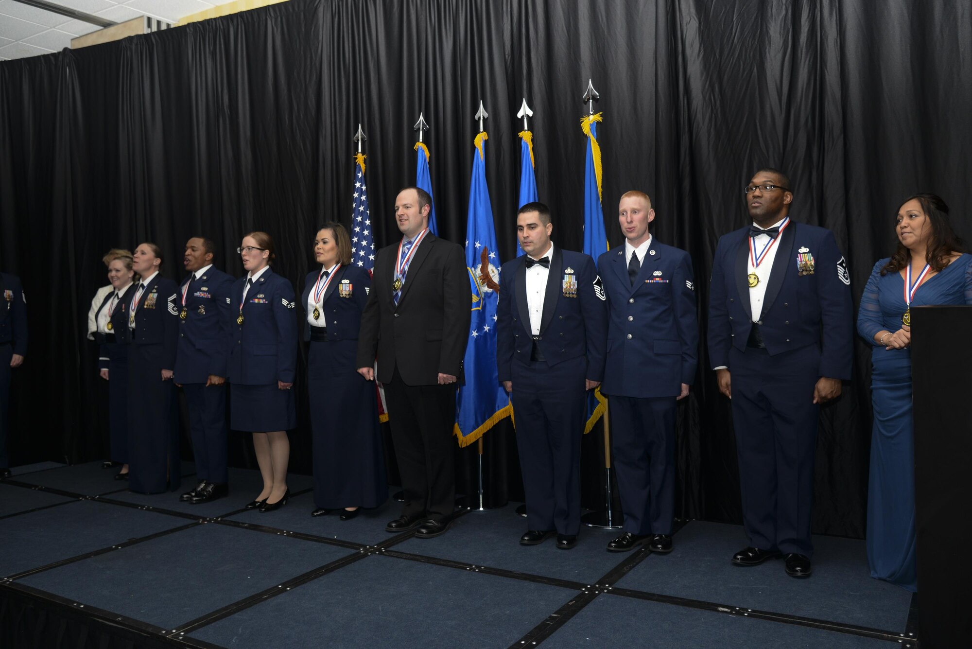 F.E. Warren Air Force Base 90th Missile Wing 2015 Annual Award winners lead a crowd in singing the Air Force Song Feb. 5, 2016, in the Cheyenne, Wyo., Holiday Inn. The crowd of friends, families and wingmen of the award winners gathered to show their support. (U.S. Air Force photo by Senior Airman Jason Wiese)